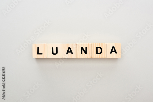 top view of wooden blocks with Luanda lettering on grey background