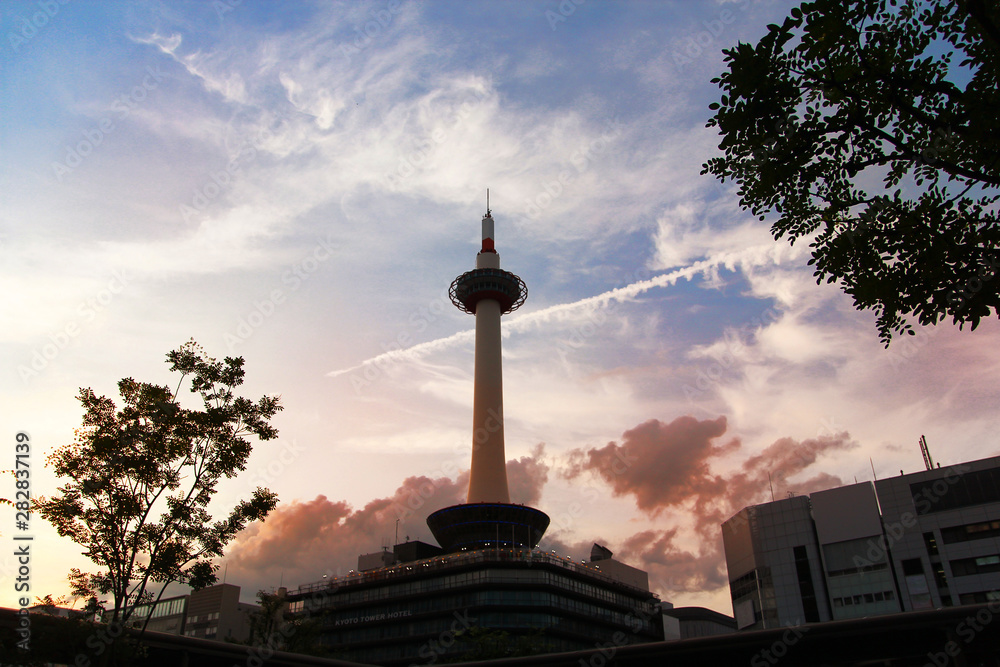 Kyoto tower and  cloud speedy in evening sun .