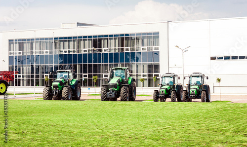 new tractors are standing next to the trading pavilion for sale in Kiev region, Ukraine.