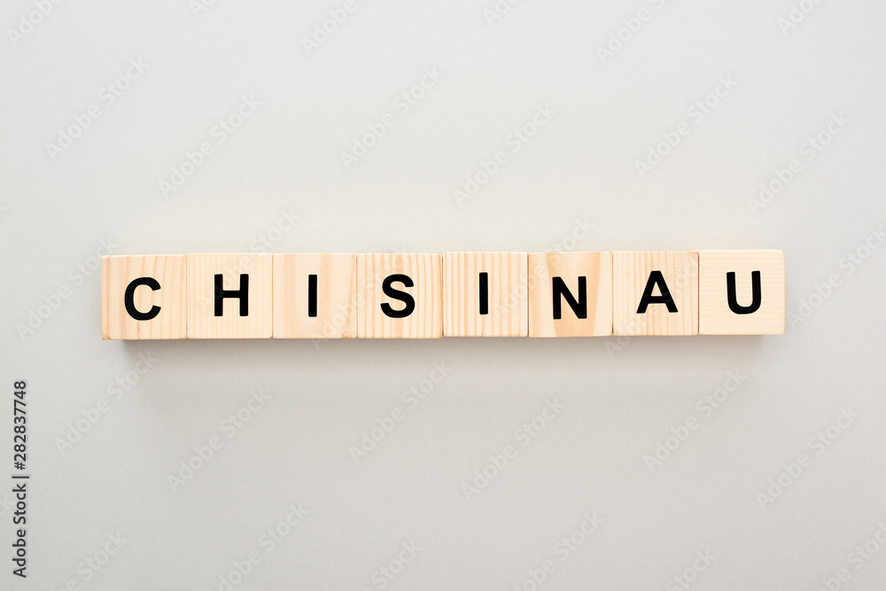 top view of wooden blocks with Chisinau lettering on grey background top view of wooden blocks with Chisinau lettering on grey background