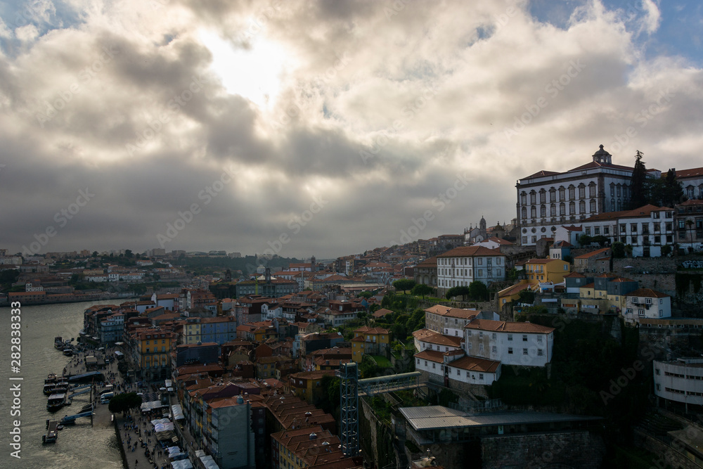 View to the city of Porto from D. Luis I bridge with cloudy sky