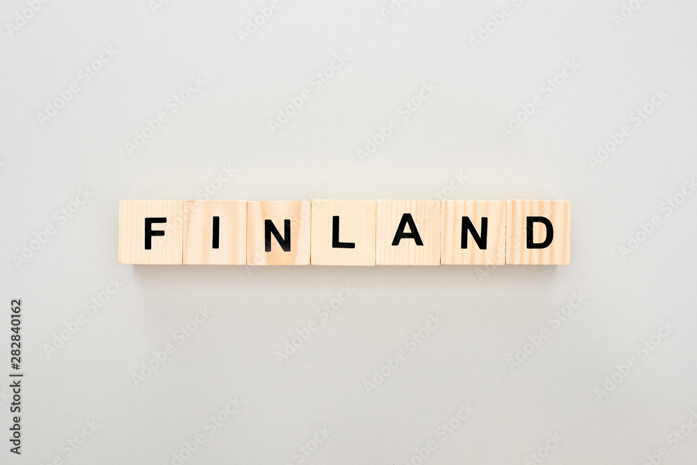 top view of wooden blocks with Finland lettering on white background top view of wooden blocks with Finland lettering on white background