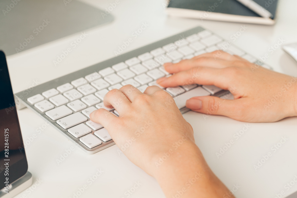 Close up of a female hands of woman office worker typing on the keyboard Close up of a female hands of woman office worker typing on the keyboard