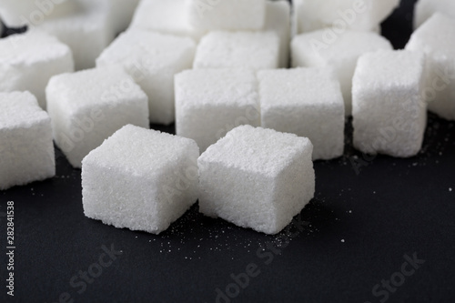 Sugar cube ingredient closeup on black background
