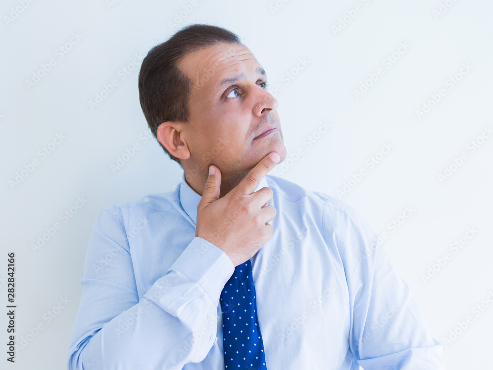Middle age man thinking clueless about a question Middle age man thinking clueless about a question
