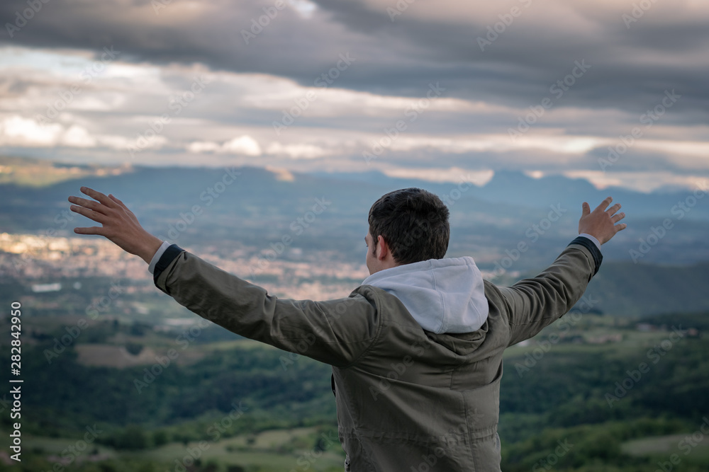 Christian worship and praise. A young man is praying and worshiping in the evening. Christian worship and praise. A young man is praying and worshiping in the evening.