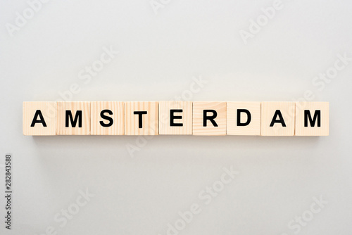 Photography top view of wooden blocks with Amsterdam lettering on grey background
