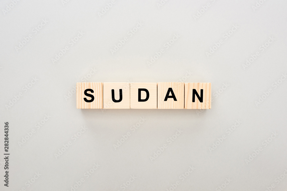 top view of wooden blocks with Sudan lettering on white background top view of wooden blocks with Sudan lettering on white background