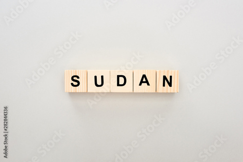 top view of wooden blocks with Sudan lettering on white background