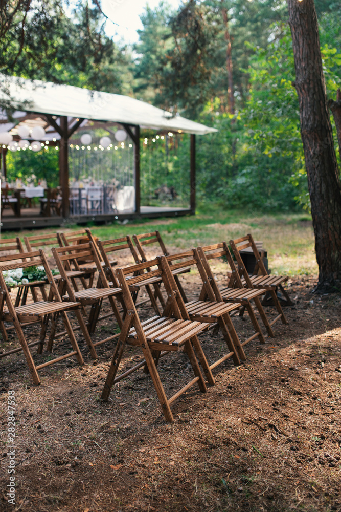 Wedding chairs set up before the ceremony. Wedding in the forest