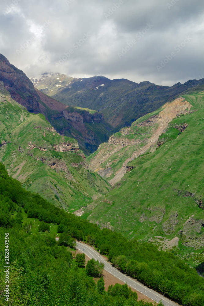 Fototapeta premium Beautiful mountain landscape. Green grass. Clouds in the sky. Travel concept.