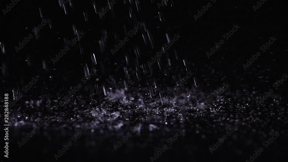 Pure water drops falling on black surface Pure water drops falling on black surface
