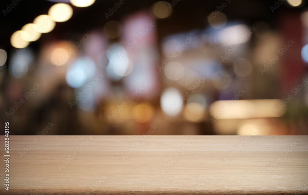 Empty dark wooden table in front of abstract blurred bokeh background of restaurant . can be used for display or montage your products.Mock up for space. Empty dark wooden table in front of abstract blurred bokeh background of restaurant . can be used for display or montage your products.Mock up for space.