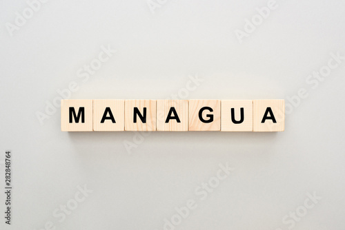 top view of wooden blocks with Managua lettering on grey background