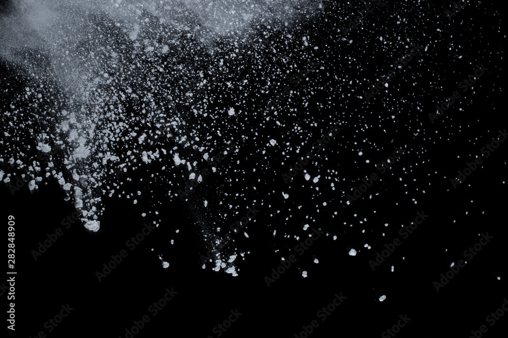 White powder explosion on black background. Colored cloud. Colorful dust explode. Paint Holi.