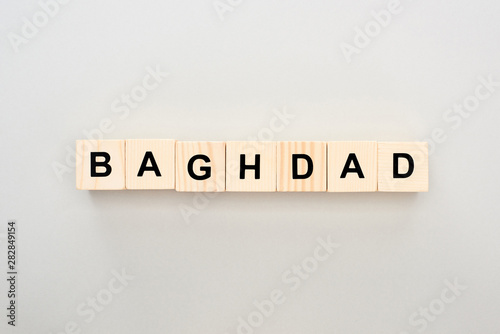 top view of wooden blocks with Baghdad lettering on grey background