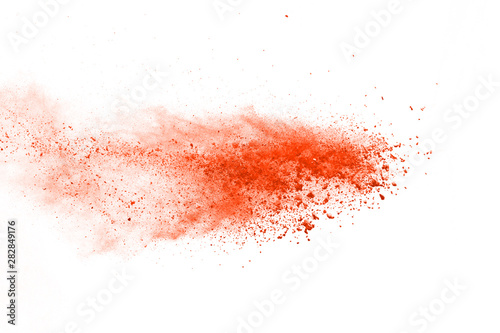 abstract orange powder splatted background,Freeze motion of color powder exploding/throwing color powder,color glitter texture on white background. photo