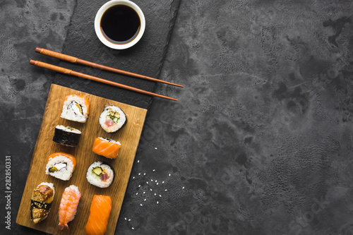 Flat lay sushi arrangement on slate background