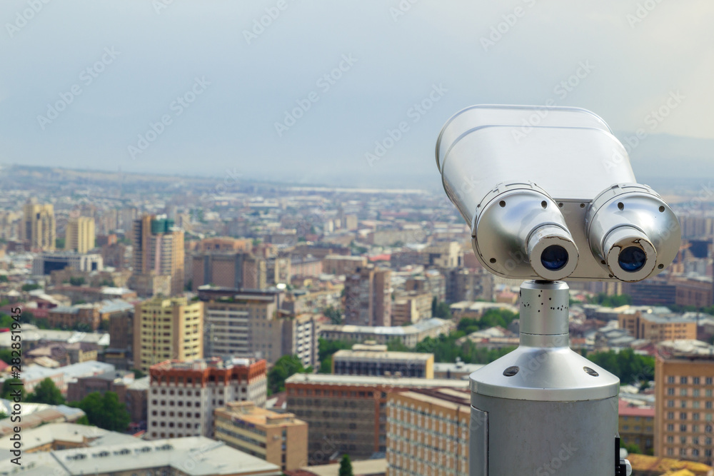 Tourist binoculars. View of the city landscape. Summer time. Travel concept Tourist binoculars. View of the city landscape. Summer time. Travel concept