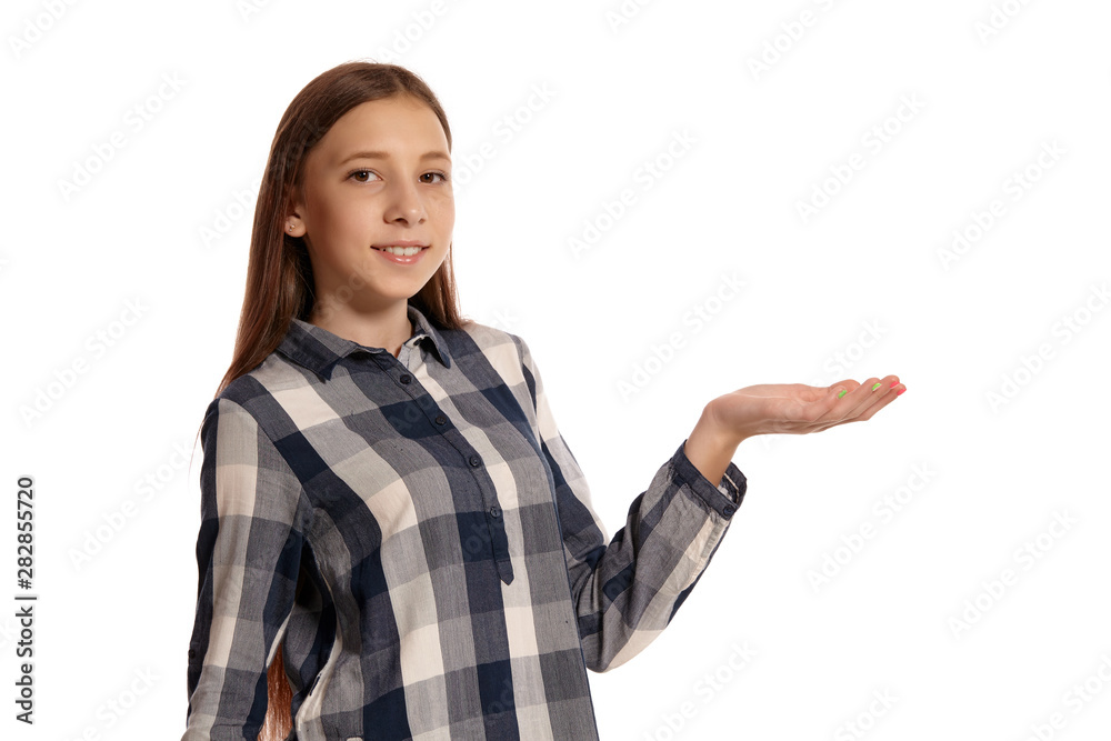 Beautiful teenage girl in a casual checkered shirt is posing isolated on white studio background. Beautiful teenage girl in a casual checkered shirt is posing isolated on white studio background.