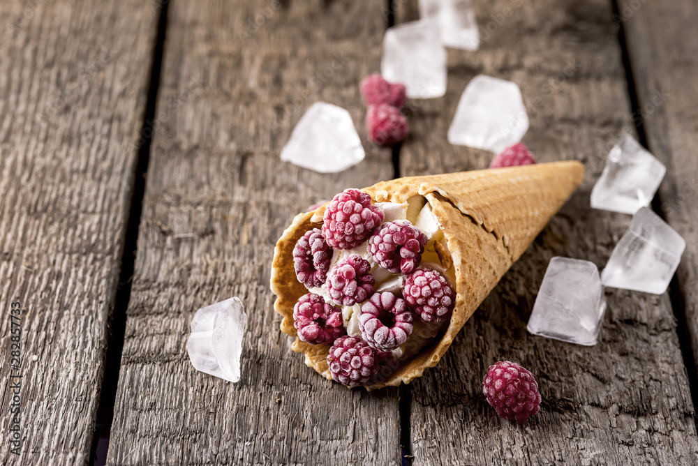 Homemade Vanilla Ice Cream in Waffle Cone with Frozen Raspberry Lying on on Rustic Wooden Background Tasty Ice Cream Summer Dessert Horizontal Copy Space