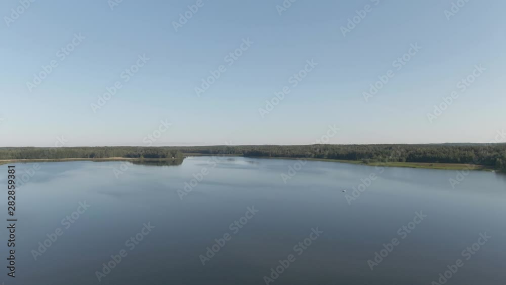 Flying over water. River with ripples. Arial drone shot. Lake, waves, coast and wild forest. Flying over water. River with ripples. Arial drone shot. Lake, waves, coast and wild forest.