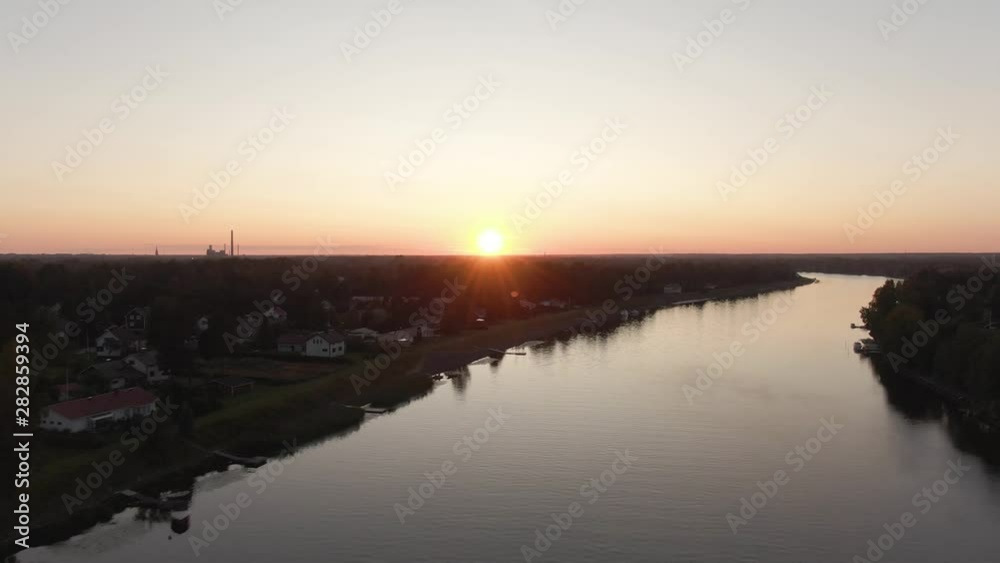 Sunset view. Drone shot of landscape with river. Golden sky and horizon. Reflection in the water. Sunset view. Drone shot of landscape with river. Golden sky and horizon. Reflection in the water.