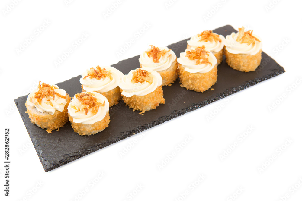 Fried sushi salmon sushimi on a black surface on white Healthy and tasty food. Fried sushi salmon sushimi on a black surface on white Healthy and tasty food.