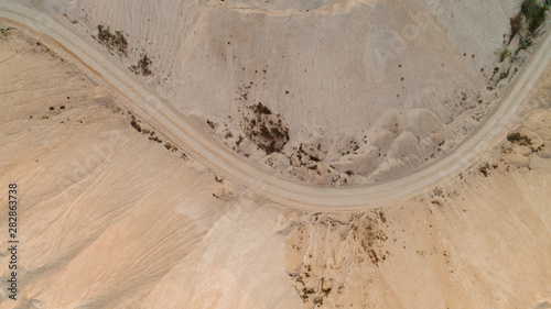 A road amidst a quarry, aerial view.
