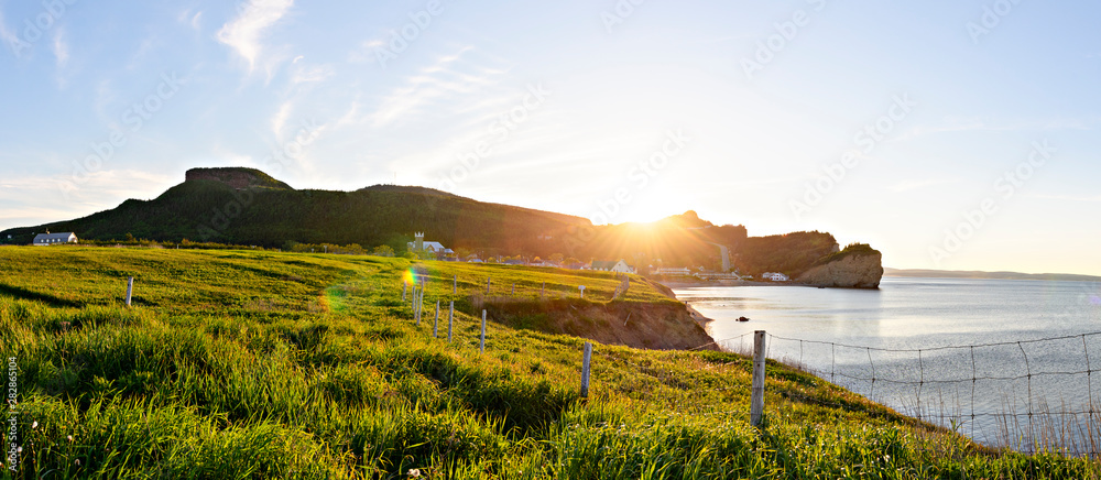 Naklejka premium A Bonaventure Island and fisherman houses and Perce Rock in Gaspesie