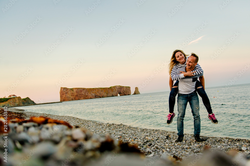 Fototapeta premium tourist couple enjoying Perce Rock view from Gaspe in Quebec