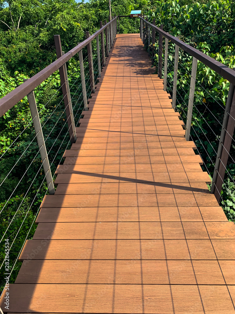 Small wooden foot bridge or walkway in the park Small wooden foot bridge or walkway in the park
