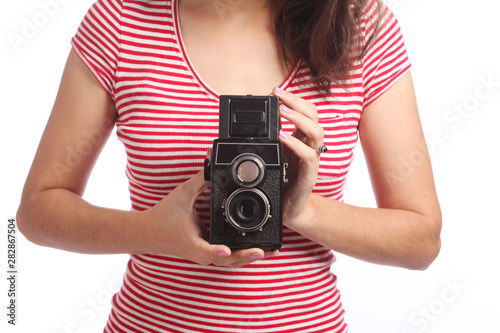 Women's hands with an old camera.