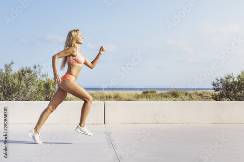 beautiful and athletic sportswoman running fast