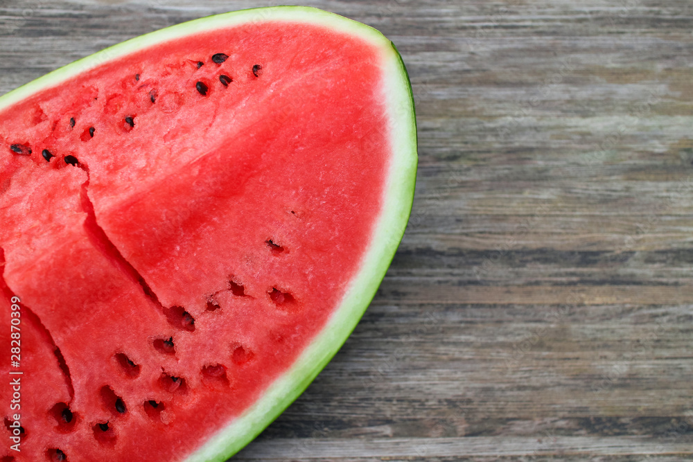 Fresh ripe watermelon on a wooden table, background on the theme of wholesome eating with space for text Fresh ripe watermelon on a wooden table, background on the theme of wholesome eating with space for text