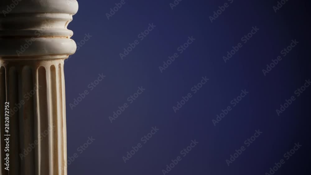 Single ancient greek column rotating slowly on color background, copy space text area Single ancient greek column rotating slowly on color background, copy space text area