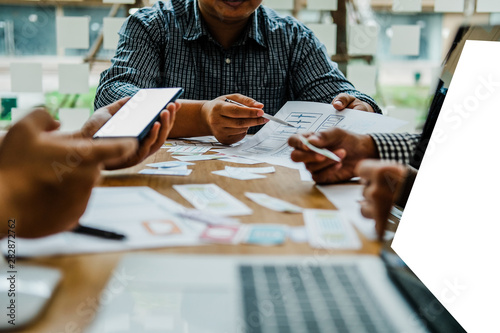 user experience UX designer designing web on smart phone layout. UI developer planning working on mobile application prototype