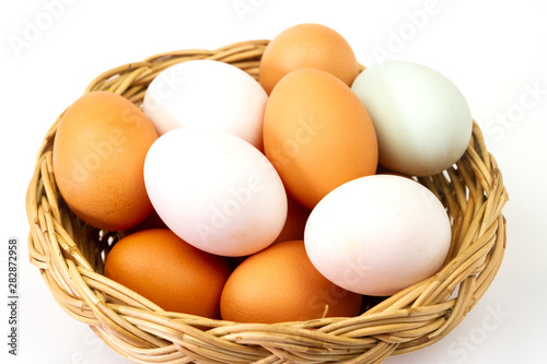 Wallpaper Mural Fresh brown and white eggs in basket isolated on white background. Torontodigital.ca
