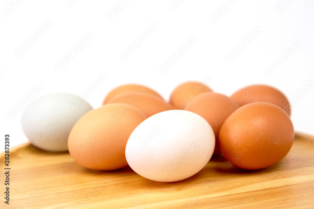 Fresh brown eggs on wooden isolate white background. Fresh brown eggs on wooden isolate white background.