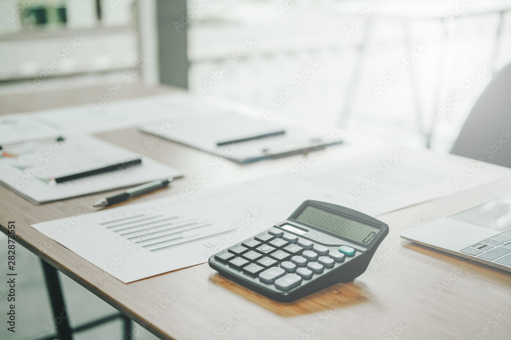 graph chart document calculator on accountant office desk table graph chart document calculator on accountant office desk table