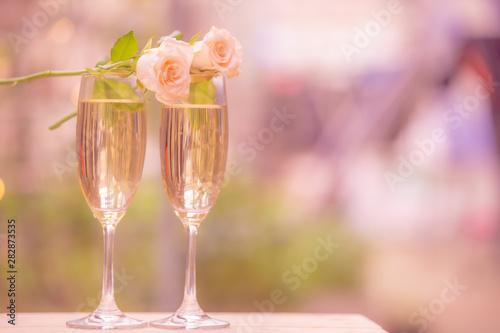Rose flower on glass wine with blur bokeh background