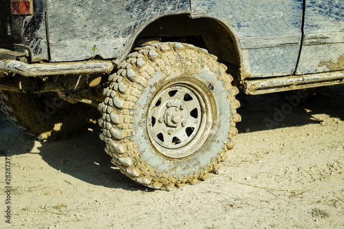Off-road dirty car wheels. Swamp rubber. Jeep in the swamp. Trial competition.