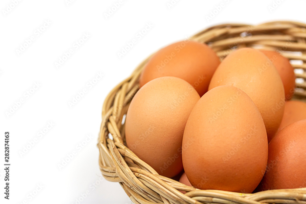 Fresh brown eggs in basket isolated on white background. Fresh brown eggs in basket isolated on white background.