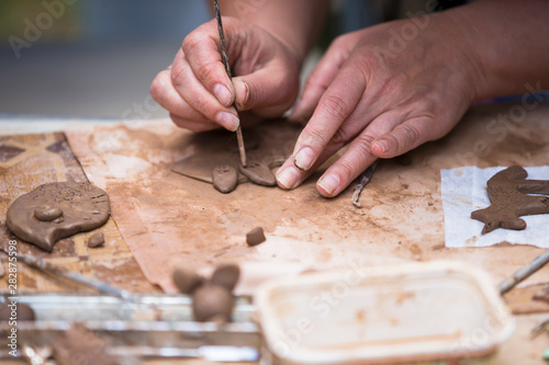 Hands make crafts from clay. Sculpt