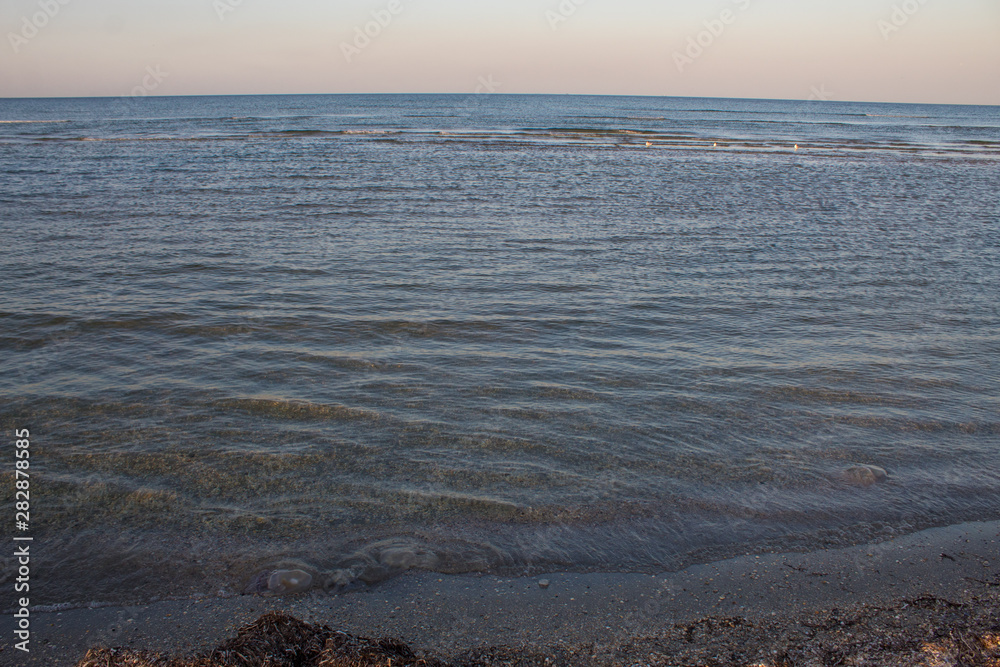 Beautiful seascape - sunset on the sea and bright pink-blue sky and blue calm sea cover.