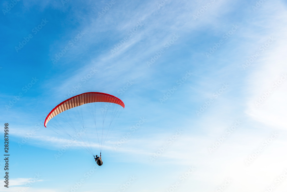 Paragliding Extreme sport, Paraglider flying on the blue sky and white cloud in Summer day at Phuket Sea, Thailand. Paragliding Extreme sport, Paraglider flying on the blue sky and white cloud in Summer day at Phuket Sea, Thailand.