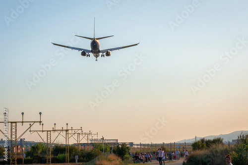 airplane landing at sunset - image