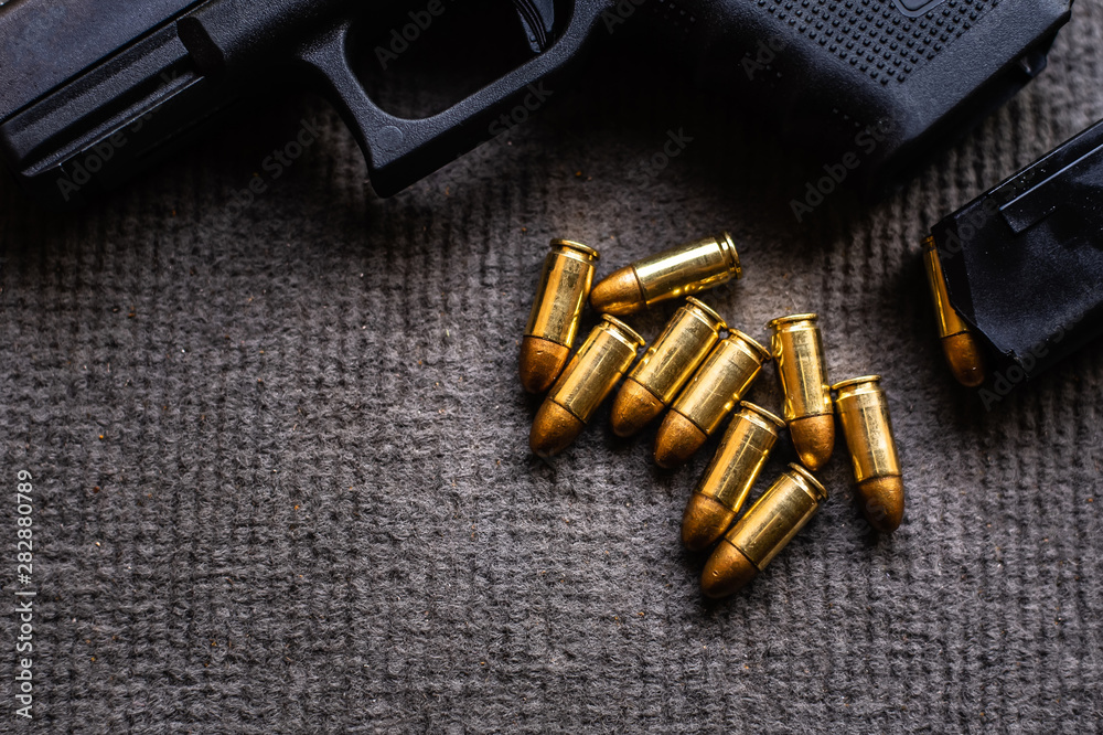 bullets and gun on black velvet desk bullets and gun on black velvet desk