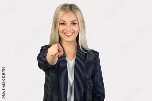 beautiful young woman in suit on white background with hand gesture