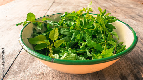 Green leafy vegetable in a beige bowl